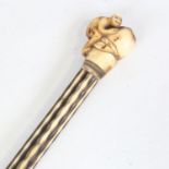 A Japanese carved ivory walking stick, circa 1900, with monkey and fruit design handle, length 89cm