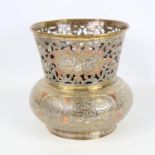 An Islamic copper and brass jardiniere, circa 1900, with silver inlaid text panels and pierced