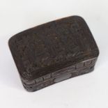 A 19th century Chinese tortoiseshell snuffbox of curved rectangular form, relief carved allover with