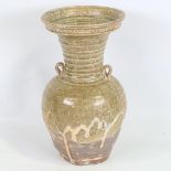 A Chinese Han Dynasty Hu form vase with ring handles, height 27cm, rim diameter 14cm