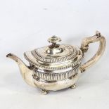A Georgian silver teapot, oval bulbous form with fluted decoration and gadrooned rim, with ivory