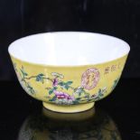 A Chinese yellow glaze porcelain bowl, with polychrome flowers, seal mark, diameter 11.5cm