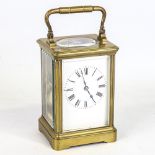 An Antique French brass carriage clock, white enamel dial with Roman numerals and ...