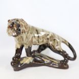 A Chinese treacle glaze ceramic tiger, 20th century, length 30cm, together with a blue and white