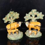Rare pair of Staffordshire Pearlware cattle and calves with bocage trees, circa 1820, height 12cm,