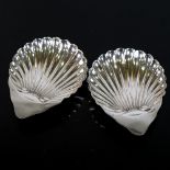 A pair of Victorian silver shell-shaped butter dishes on bun feet, by George Unite, hallmarks
