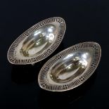 A pair of Victorian oval silver sweetmeat dishes, pierced borders on 4 feet, by Goldsmiths &