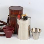 A plated stirrup cup set, containing 3 decanters and drinking tots in cylindrical leather case, case