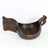 A large Russian carved and stained wood bowl, in the style of a Kovsh, length 48cm