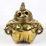 A Chinese polished bronze incense burner and cover, with elephant handles, height 17cm