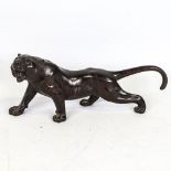 A Japanese patinated bronze striped tiger, seal mark under base, length 24cm