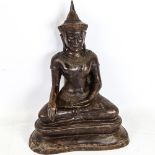 A Chinese patinated bronze seated deity, height 37cm