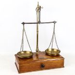 Victorian brass balance scales, on mahogany base with drawer under and weights, by V H Marsden &