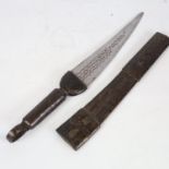 An African hunting knife, with embossed leather scabbard and handle, overall length 44cm