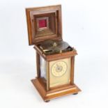 A 19th century German walnut-cased symphonion table clock, carved and brass-mounted case, the top