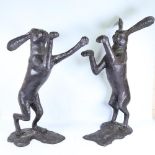 A pair of large patinated bronze boxing hare garden sculptures, largest height 88cm