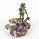 A verdigris bronze sculpture of a child, on natural amethyst geode base, unsigned, height 12cm