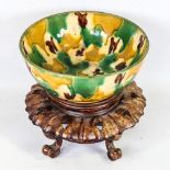 A 19th century or earlier Chinese egg and spinach glaze ceramic bowl, diameter 17cm, on hardwood