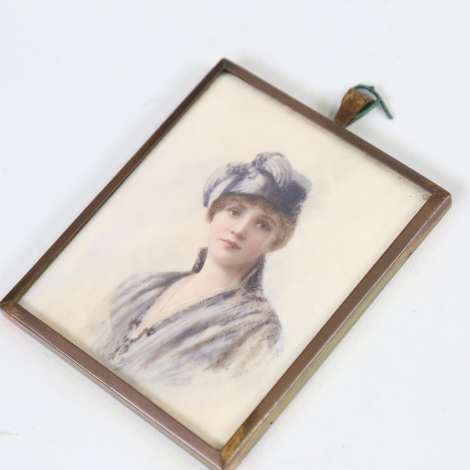 A miniature watercolour on ivory, portrait of a woman, circa 1920, unsigned, brass frame, overall - Image 2 of 3