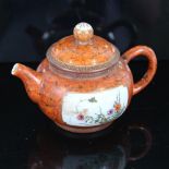 A Chinese red glaze porcelain teapot, finely enamel painted floral panels, seal mark, height 11cm