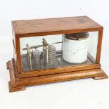 An oak-cased barograph, circa 1900 - 1920, case length 30cm, on oak shelf bracket