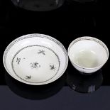 A Chinese white glaze porcelain cup and saucer, with painted decoration, bowl diameter 9cm