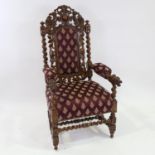 Victorian Carolean style oak armchair, with phoenix decorated pediment and lion mask arms