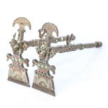 A pair of South American brass ceremonial axes, with inset coloured glass bosses, length 30cm