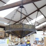 An octagonal pierced metal hanging light fitting, with amber glass inserts, 53cm across