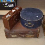 A travel trunk, a hat box, and a small suitcase