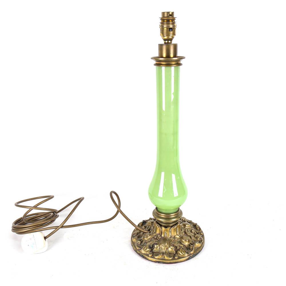 A green glass table lamp, on embossed brass base, height 48cm overall
