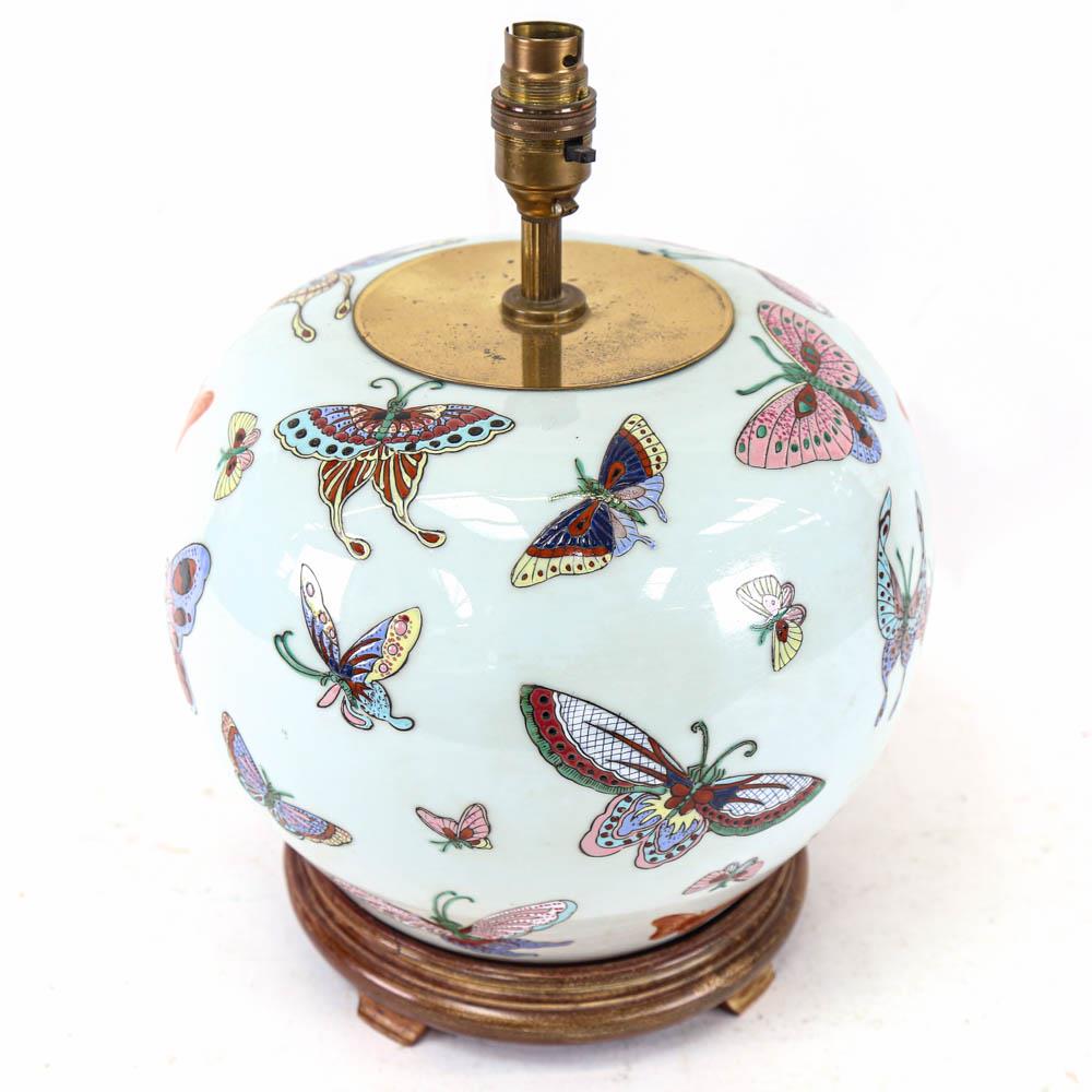 Chinese ceramic butterfly design table lamp, on wooden stand, height 34cm including fitting