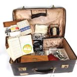 A Vintage suitcase containing various items, including RAF photograph, clothes brushes, silver