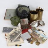 Various military ephemera, including trench art cannon shell vases, cap badges, postcards etc (