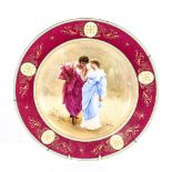 A large Royal Vienna wall plate, Liebesfruhling, depicting couple with a rose, signed, diameter
