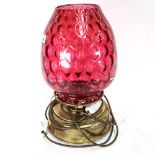 A brass oil lamp with cranberry glass light shade, height 42cm (A/F)