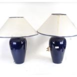 A pair of blue glazed ceramic table lamps, and shades, height 58cm overall