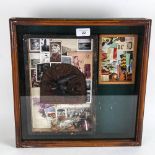 A glazed wall-mounted display case, containing family memorabilia, height 38cm