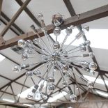 An unusual polished metal ceiling light fitting, diameter 60cm