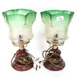 A pair of converted brass oil lamps, with etched green glass shades, height 35cm