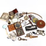 A box of items, including daguerreotypes, small bells, AA badge etc