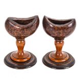 A pair of Antique treen eye baths, on turned pedestals, height 10cm