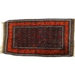 A red and blue ground Persian design rug, with symmetrical pattern, 179cm x 103cm