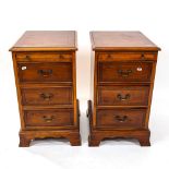 A pair of yew wood and ebony-strung bedside chest, having brushing slide and 3 short drawers each,