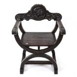 An Italian design relief carved X-framed chair