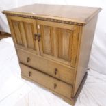 cA 1920s oak tallboy, with 2 linenfold cupboards and cm, Hdrawers under, on bracket feet, W81cm,