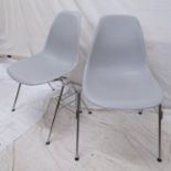 A Charles Eames for Vitra, a pair of DSS side chairs with grey plastic shell seats, and maker's
