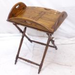 A reproduction oak butler's tray on folding stand