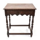 A 1920s oak side table, single carved frieze drawer with divisional inserts, raised on baluster