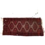 A small Afghan design red ground rug, 112cm x 60cm